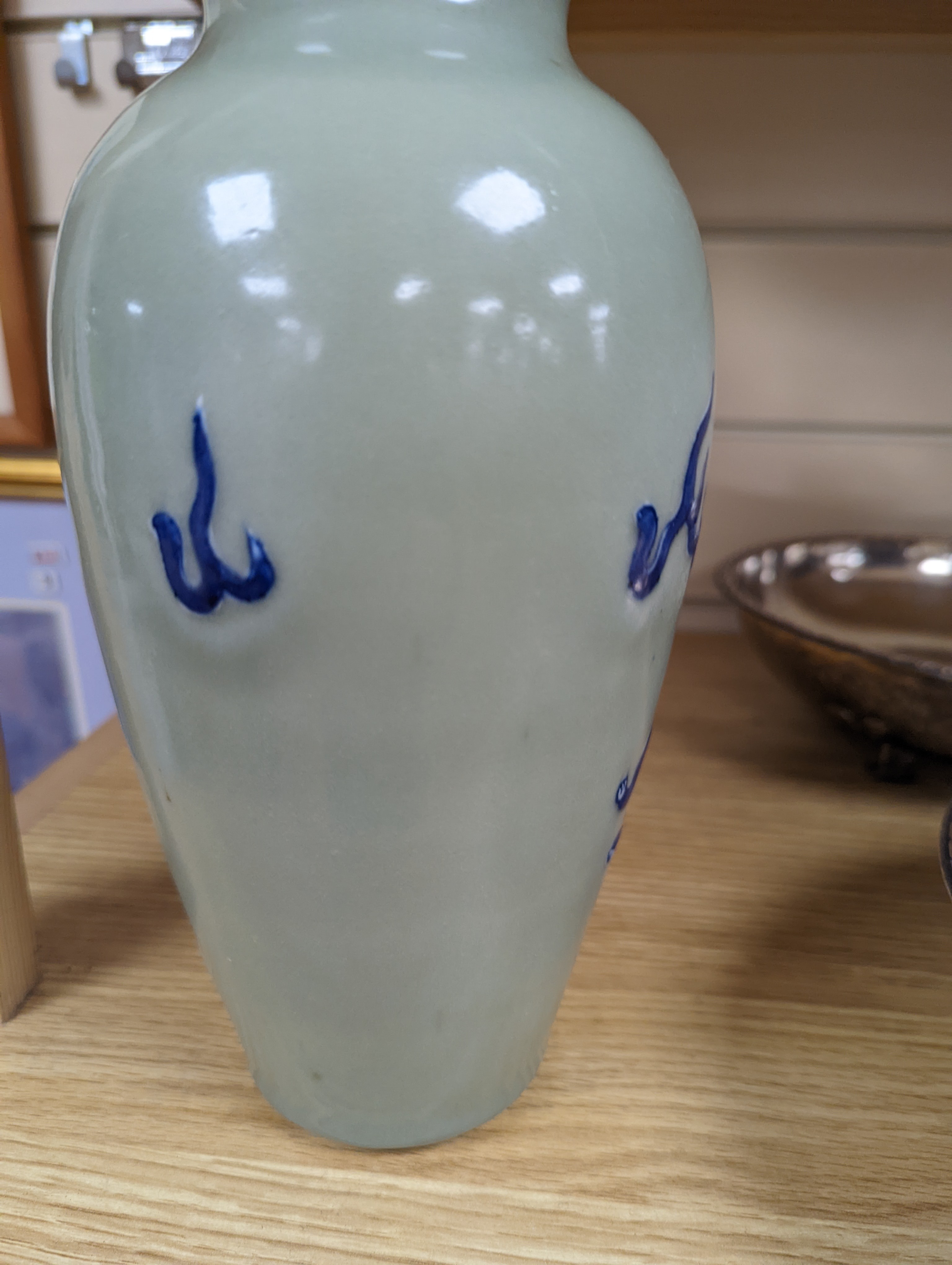 A Chinese celadon glazed vase, 24cm and a Chinese famille rose teapot and matching cream jug, a.f.
